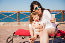 Mom and Little Girl Taking a Selfie and Smiling