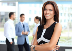 Business Woman Smiling in Front of Other Co workers