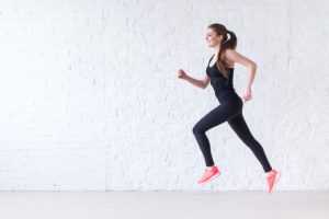 Female in Black Workout Clothes Running