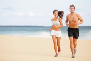 Young Couple Running Along the Beach