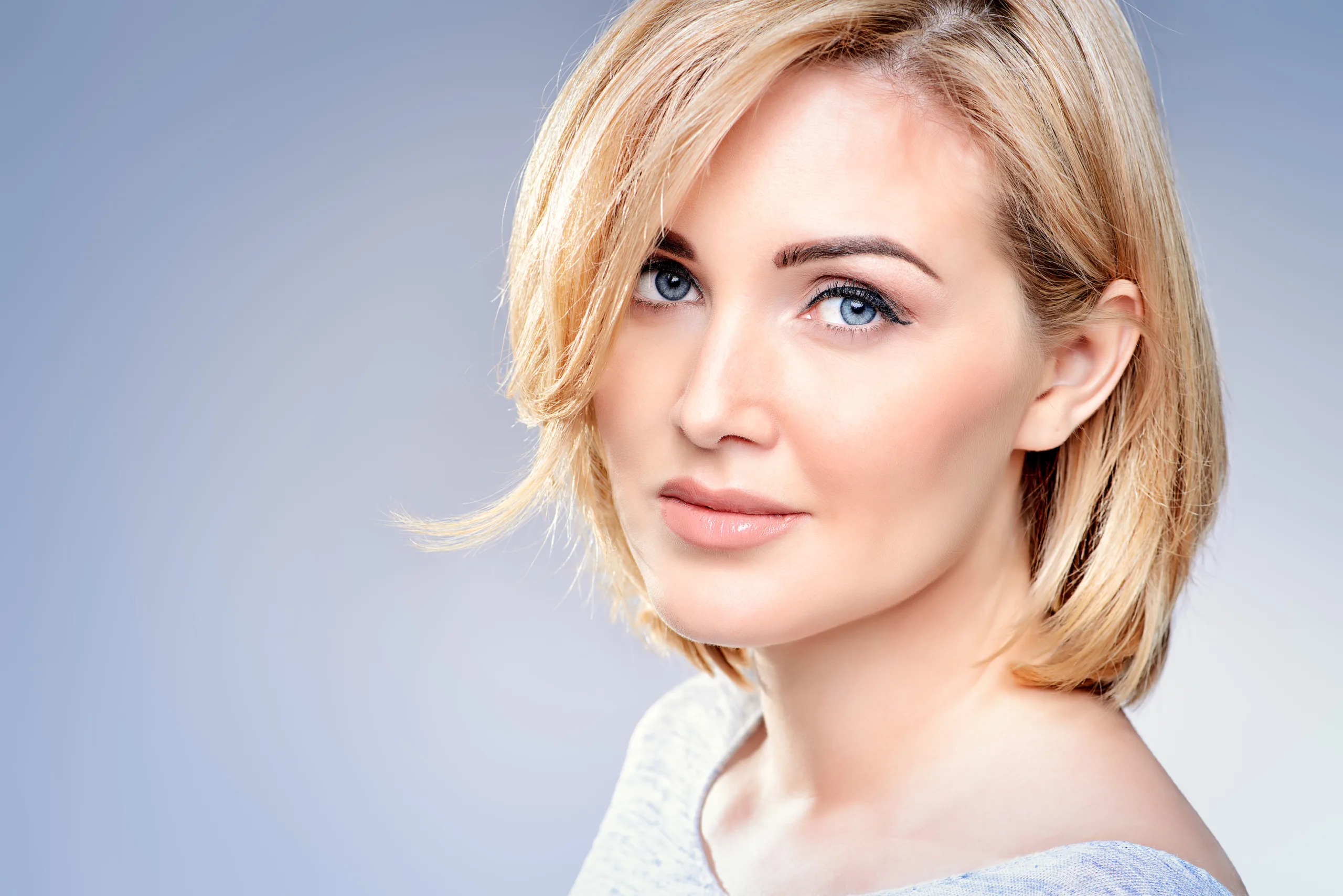 Female with blue eyes and short blond hair