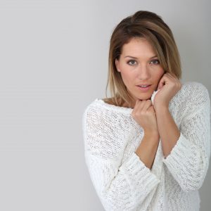 Woman Pulling Sweater Up to Her Cheeks