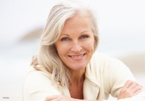 Smiling Mature Woman in Beige Sweater