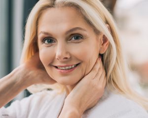 Attractive Older Woman with Hands on Neck