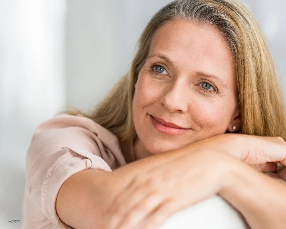 Older woman with blue eyes resting head