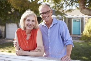 Older Couple in Front of their Home