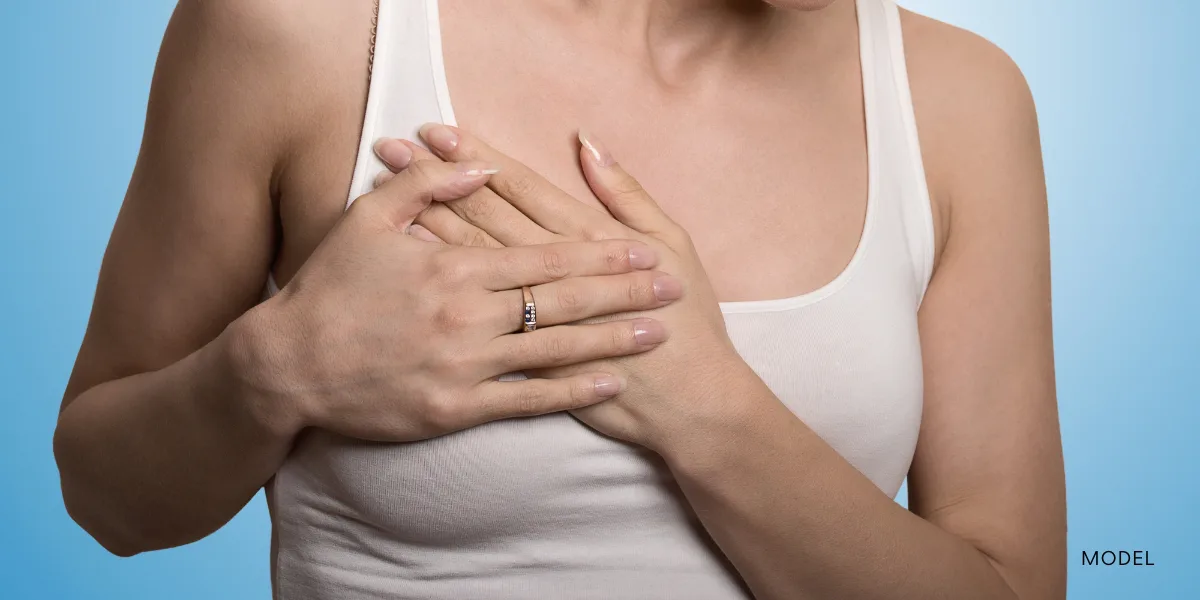 Female model placing hands over breasts