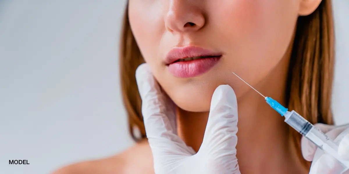 Close-up of lip filler injection being performed as a non-surgical cosmetic treatment at a med spa